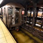 A worker exits a stalled subway train in the Lincoln Center station, in New York, . A water main break flooded streets on Manhattan's Upper West Side near Lincoln Center and hampered subway service during the Monday morning rush hour